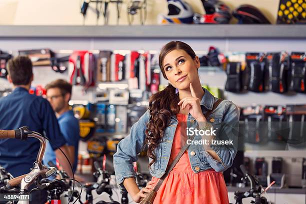 Young Woman In Bike Store Stock Photo - Download Image Now - Buying, Choice, Choosing