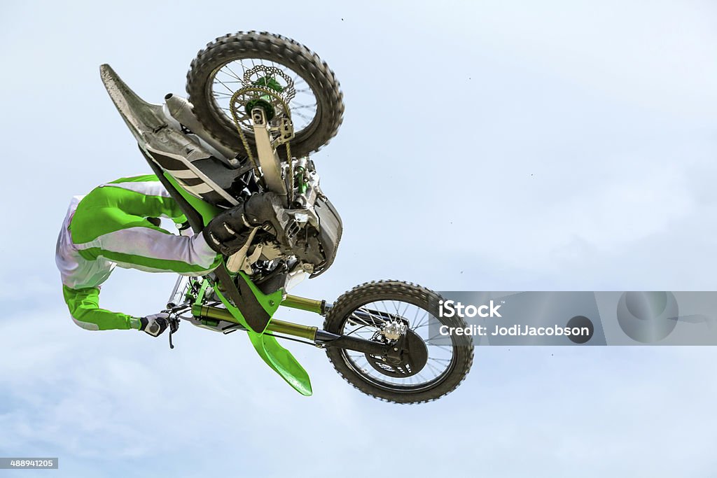 Man on a dirt bike mid air Mid air shot of man riding a dirt bike.  RM Green Color Stock Photo
