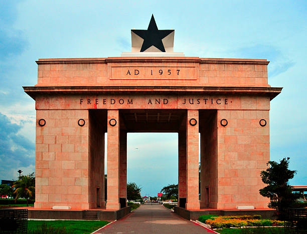 Aerial view of Accra Ghana Black Star Gate illuminated at night, landmark monument.
