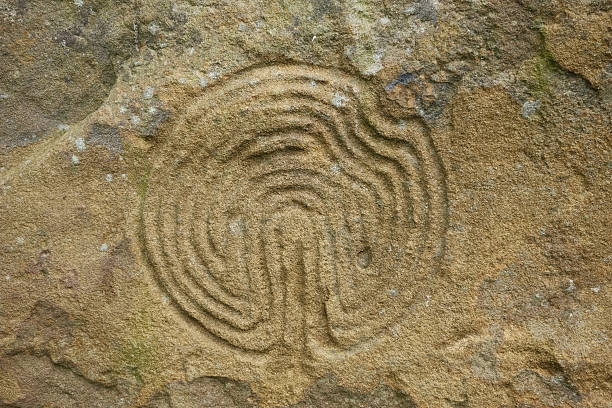 istock Ancient maze carved on rock 488941643