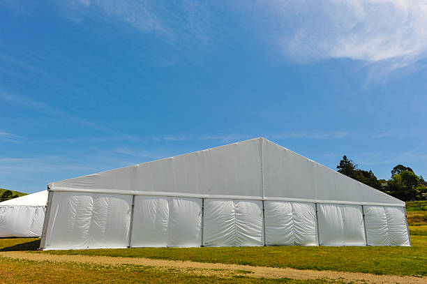istock Large white party tent if a field 488943049