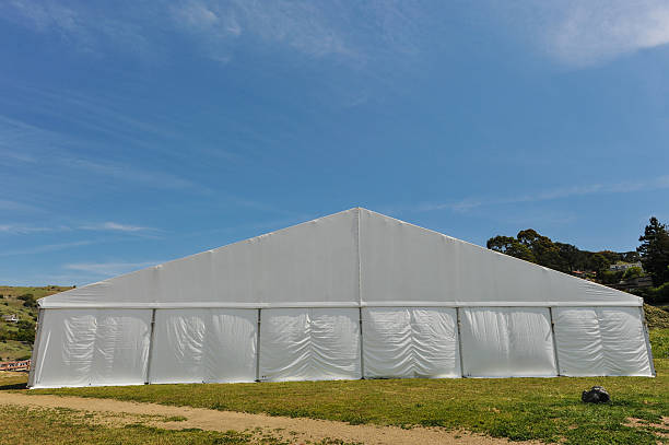 istock Large white party tent if a field 488943051