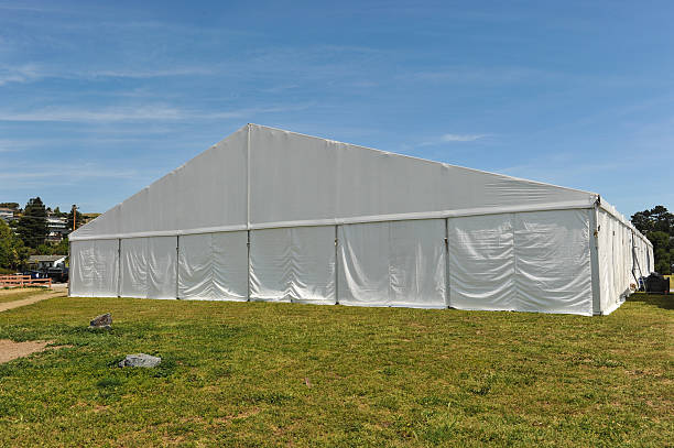 istock Large white party tent if a field 488943055