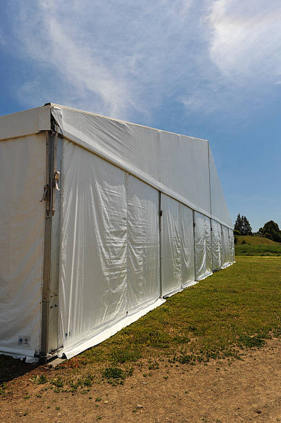 istock Large white party tent if a field 488943059