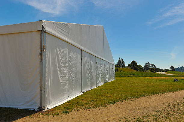 istock Large white party tent if a field 488943063