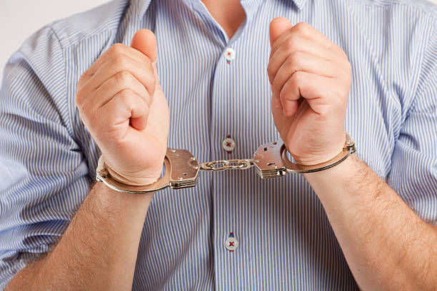 istock Close up of a man in handcuffs arrested 488943551