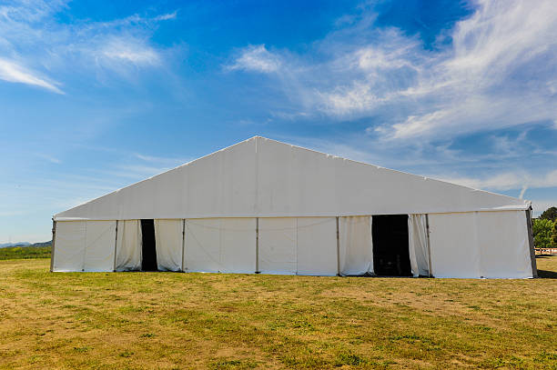 istock Large white party tent if a field 488943613