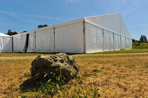 istock Large white party tent if a field 488943617