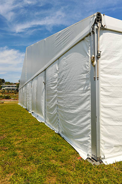 istock Large white party tent if a field 488943619