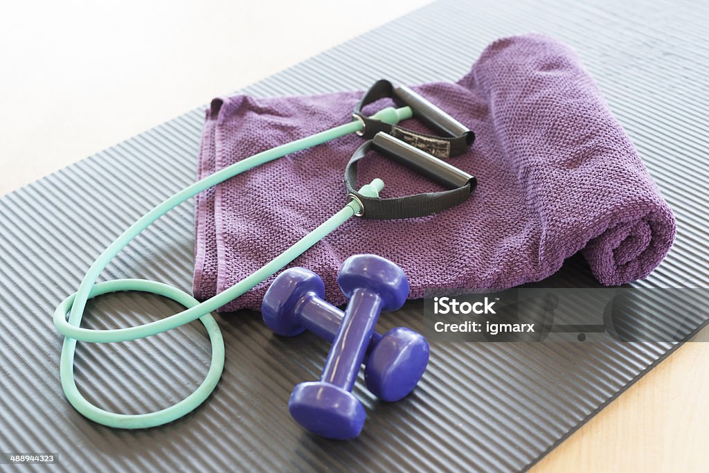 weight and jump- rope gymnastic rug, towel, jump rope and dumbbells from fitness studio Activity Stock Photo