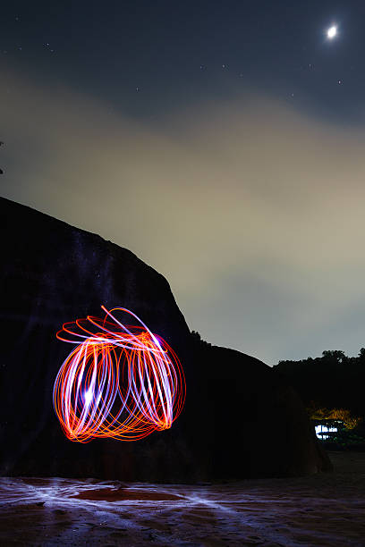 istock Burning steel wool.On the beach at night. 488947198