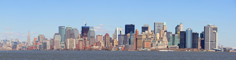 Skyscrapers on Manhattan, New York, USA with a jetty on Liberty island in the foreground.