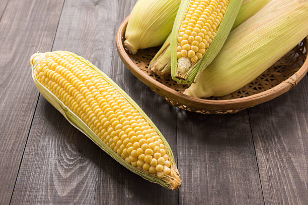 istock Fresh organic yellow sweet corn on wooden table 488950608