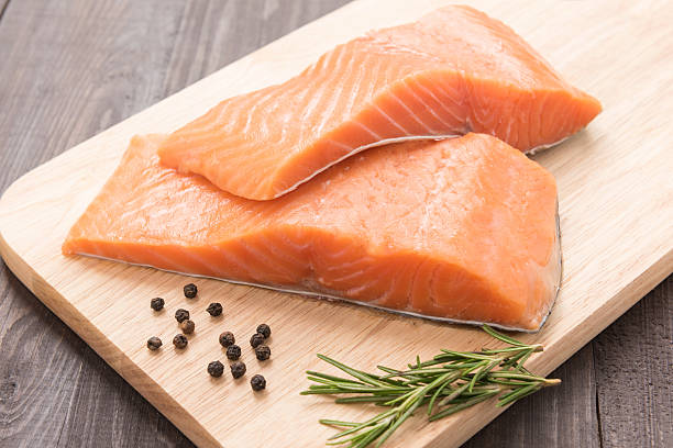 istock Fresh salmon and pepper on the wooden table 488951588