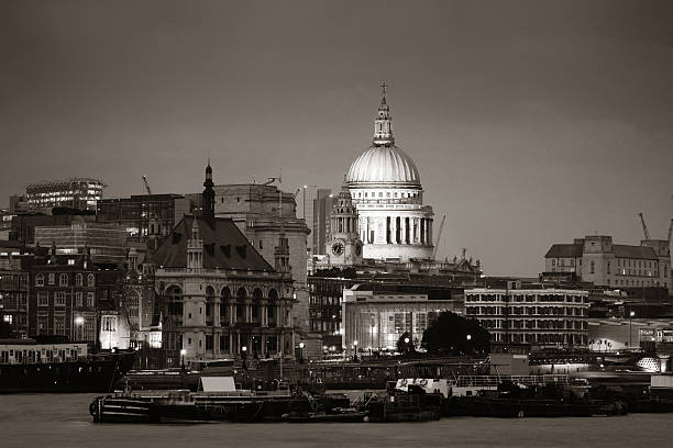 St Pauls Cathedral over Thames River at night in London in black and white.