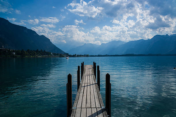 Pier on Lake Geneva Old pier on the water of Lake Geneva in Switzerland. chateau de chillon photos stock pictures, royalty-free photos & images