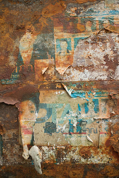 istock Weathered paper Flyers on Rusty Metal Wall in Thailand 488953190