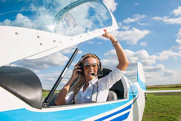istock Woman pilot looking at camera, preparing for flying 488954738