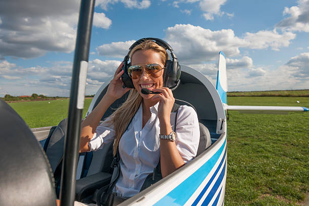 istock Woman pilot looking at camera, preparing for flying 488955010