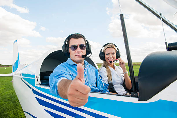 istock Woman and man pilot looking at camera, preparing for flying 488955254