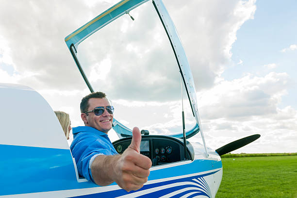 istock Woman and man pilot looking at camera, preparing for flying 488955322