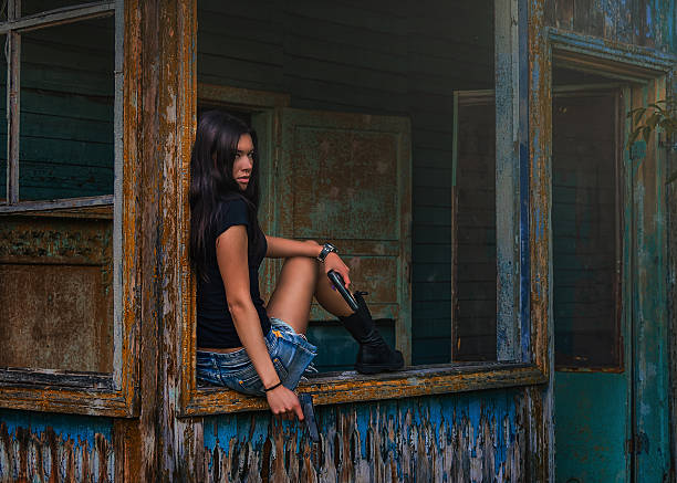 Beautiful young woman soldier with a gun