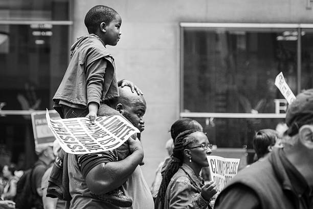 Young boy carried on the shoulders of a man, NYC stock photo