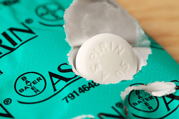 Half gram Bayer Aspirin tablet on blister pack Idar-Oberstein, Germany - May 7, 2014: One Aspirin tablet, containing 0.5 gram of acetylsalicylic acid as  active pharmaceutical ingredient, located on its blister pack with ten tablets. Aspirin is one of the most common and used pharmaceutical drugs worldwide. In 1897 Aspirin was first synthesized by the german company Bayer. It was mainly used to relieve pain and aches, but today it is also known to help to lower the risk for strokes, heart attackes and maybe some type of cancer if taken in low dosis regulary. This packaging is the one being sold in Germany. aspirin photos stock pictures, royalty-free photos & images