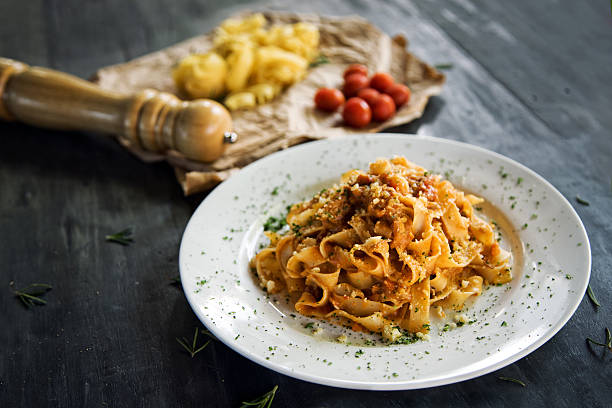 Homemade pasta Homemade fettucine pasta with bolognese sause condiment photos stock pictures, royalty-free photos & images