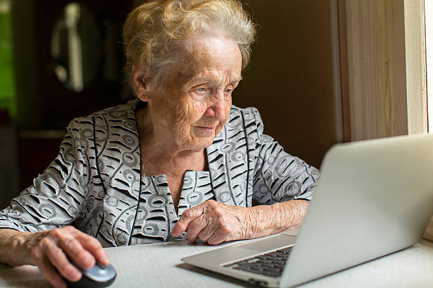 istock Elderly woman working on a laptop. 488960956