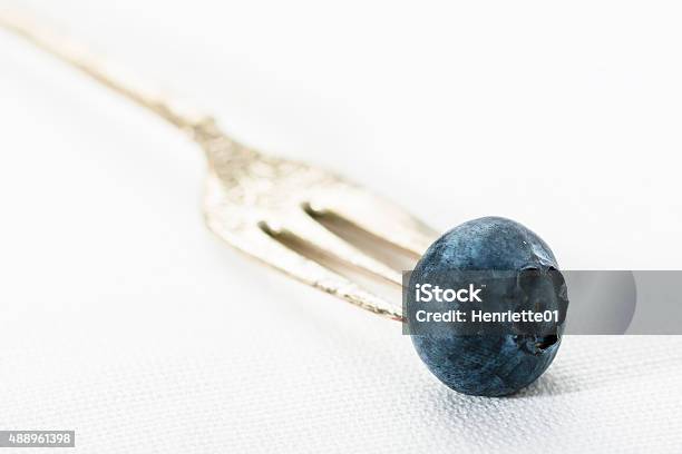 Singe Blueberry On A Silver Fork Stock Photo - Download Image Now - 2015, Blueberry, Close-up