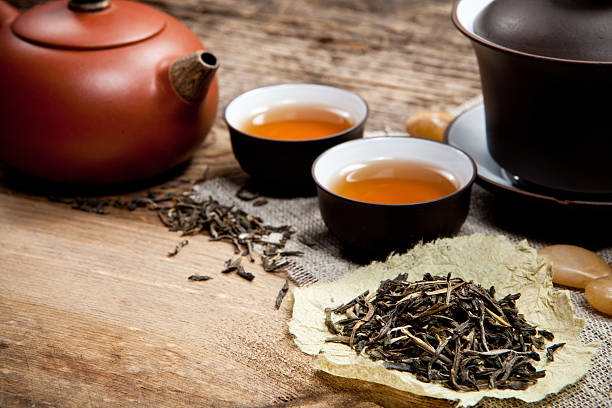 istock Tea cups with teapot on old wooden table 488961543
