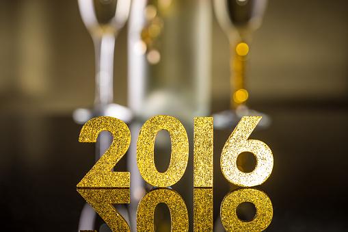 2016 year golden figures on reflection background
