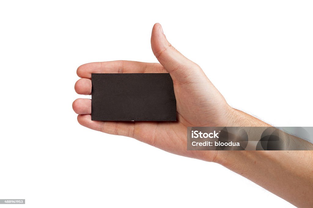 Businessman's hand holding blank business card Businessman's hand holding blank paper business card, closeup isolated on white background Adult Stock Photo