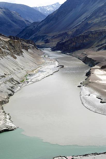 Confluence of rivers  1 The confluence of the Zanskar River (from top) and the Indus (bottom flowing from left to right) is 3 km southeast of Nimmu village in Ladakh in J&K state ,India.Famous for river rafting activities. prayagraj photos stock pictures, royalty-free photos & images