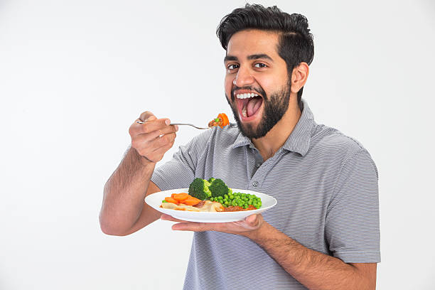 Indian Man Eating Handsome Indian man eating home cooked meal healthy indian food stock pictures, royalty-free photos & images