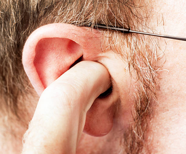 istock Mature, bearded man digs finger into his ear 488962091