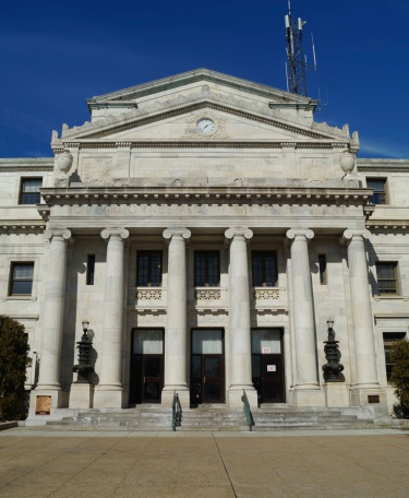 Moose Jaw ,Saskatchewan, Canada- July 2,2023:   Beaux Arts Building built in 1904. Now The  Moose Jaw City Hall . Architectural Style is Edwardian Classical. Contrasted with a modern 21st Century Car.