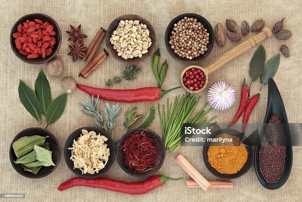 Culinary Herbs and Spices Large herb and spice selection in wooden bowls and loose. Antioxidant Stock Photo