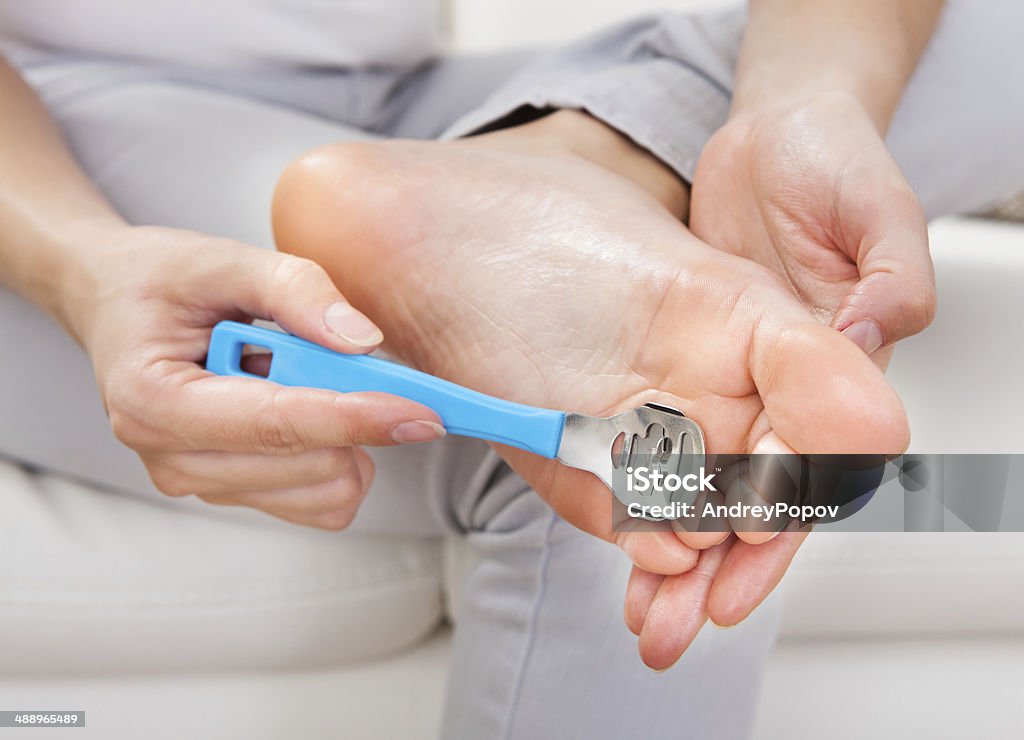 Woman having pedicure to her legs Close-up of woman having pedicure to her legs Activity Stock Photo