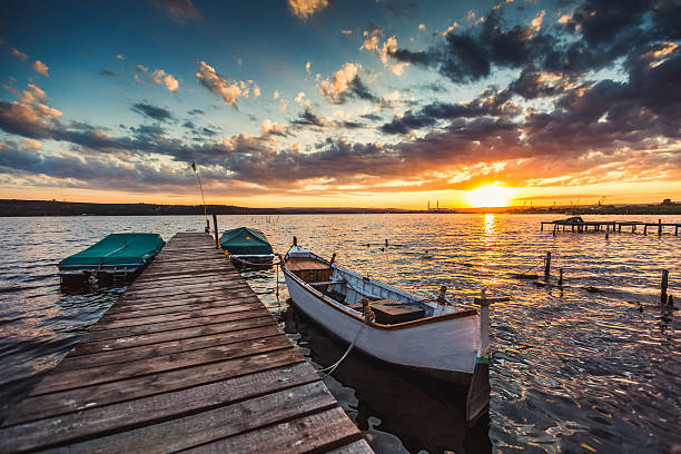 istock Peaceful sunset with dramatic sky and boats and a jetty 488974216