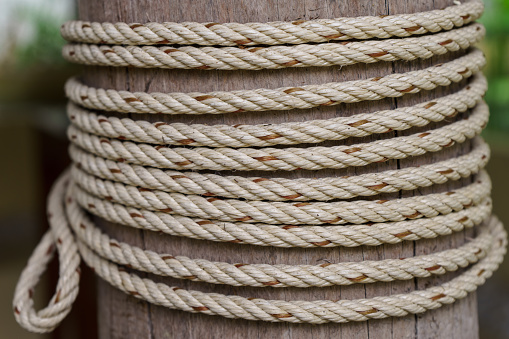 Rope tied to a wooden pole, rope detail with wooden pillar