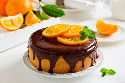 Orange cake with chocolate and orange slices.