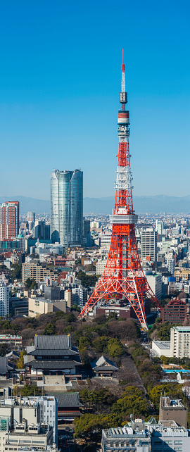 The iconic red and white spire of Tokyo Tower rising high above the crowded cityscapre of downtown Tokyo, Japan. ProPhoto RGB profile for maximum color fidelity and gamut.