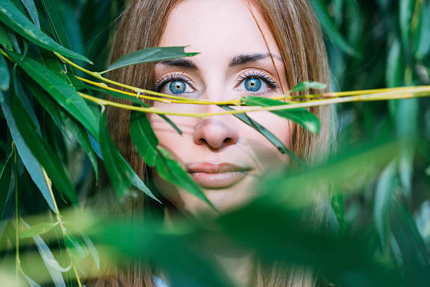 istock Portrait of a girl with blue eyes inside willow tree 488976636