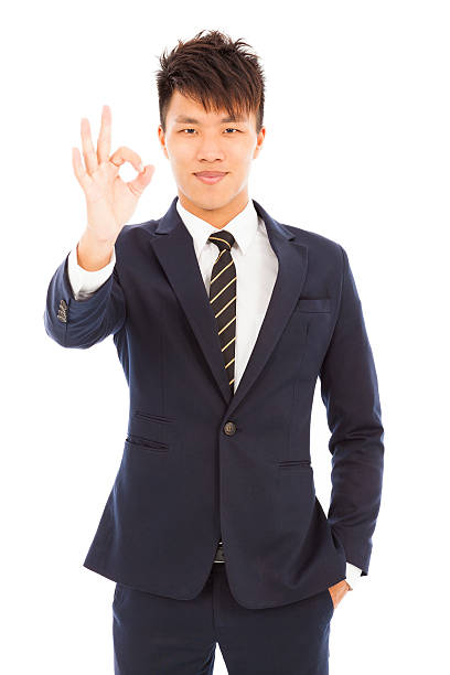 istock young businessman with ok gesture 488977243