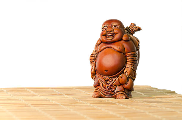 Statuette of laughing Buddha on a white background Statuette Hotei or the Laughing Buddha - the God of Wealth, joy and prosperity on a white background. hotei the god of happiness stock pictures, royalty-free photos & images