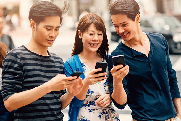 istock Happy japanese friends surfing the net 488978056