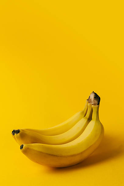 istock Ripe bananas on the yellow background 488978492