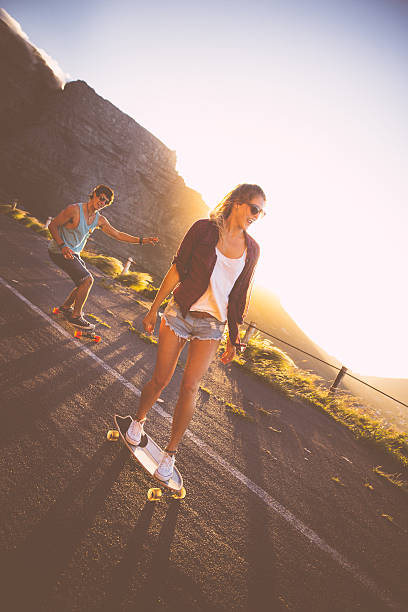 istock Skater couple longboards road 488979659